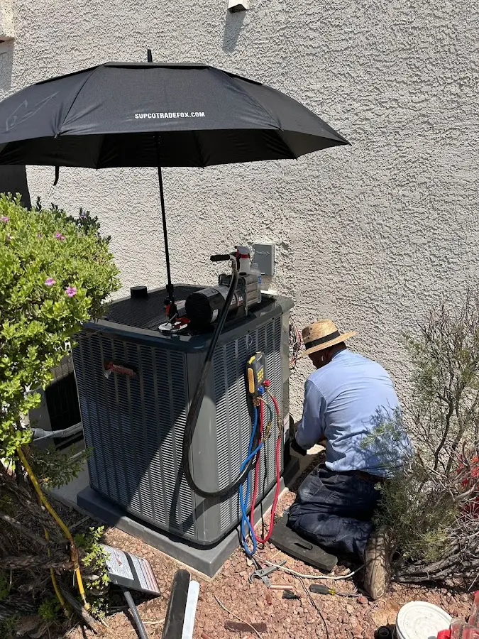 HVAC technician performing outdoor AC maintenance in Coos Bay